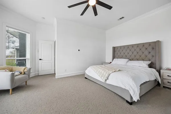 a bedroom with a bed couch and window