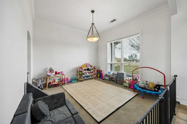 a view of a room that has a bed and a chandelier