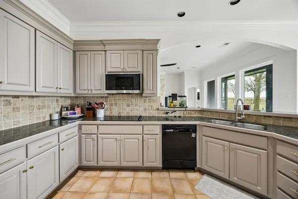 a kitchen with a sink stove and cabinets
