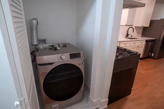 a view of a storage and utility room with a sink