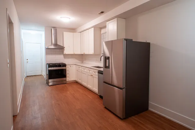 a kitchen with stainless steel appliances granite countertop a refrigerator stove and sink