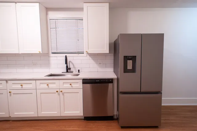 a kitchen with cabinets and stainless steel appliances