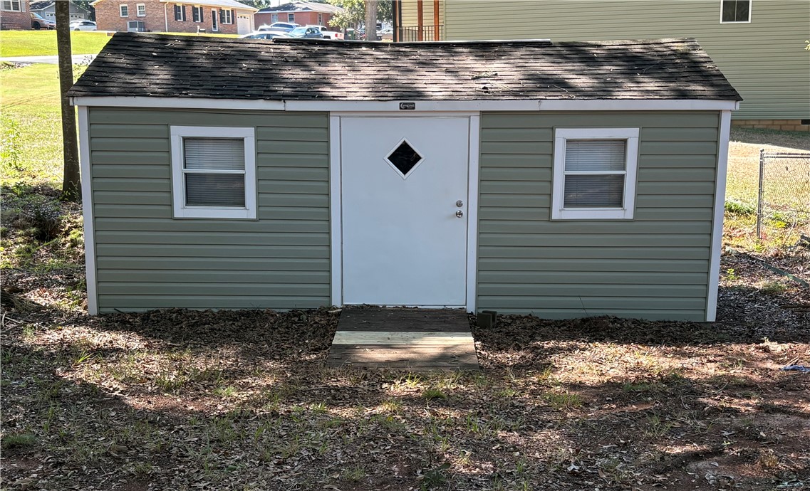 306 Hemlock Avenue Anderson, SC 29625 - Photo 23 of 25 A detached backyard structure provides versatile storage space with a shingled roof.