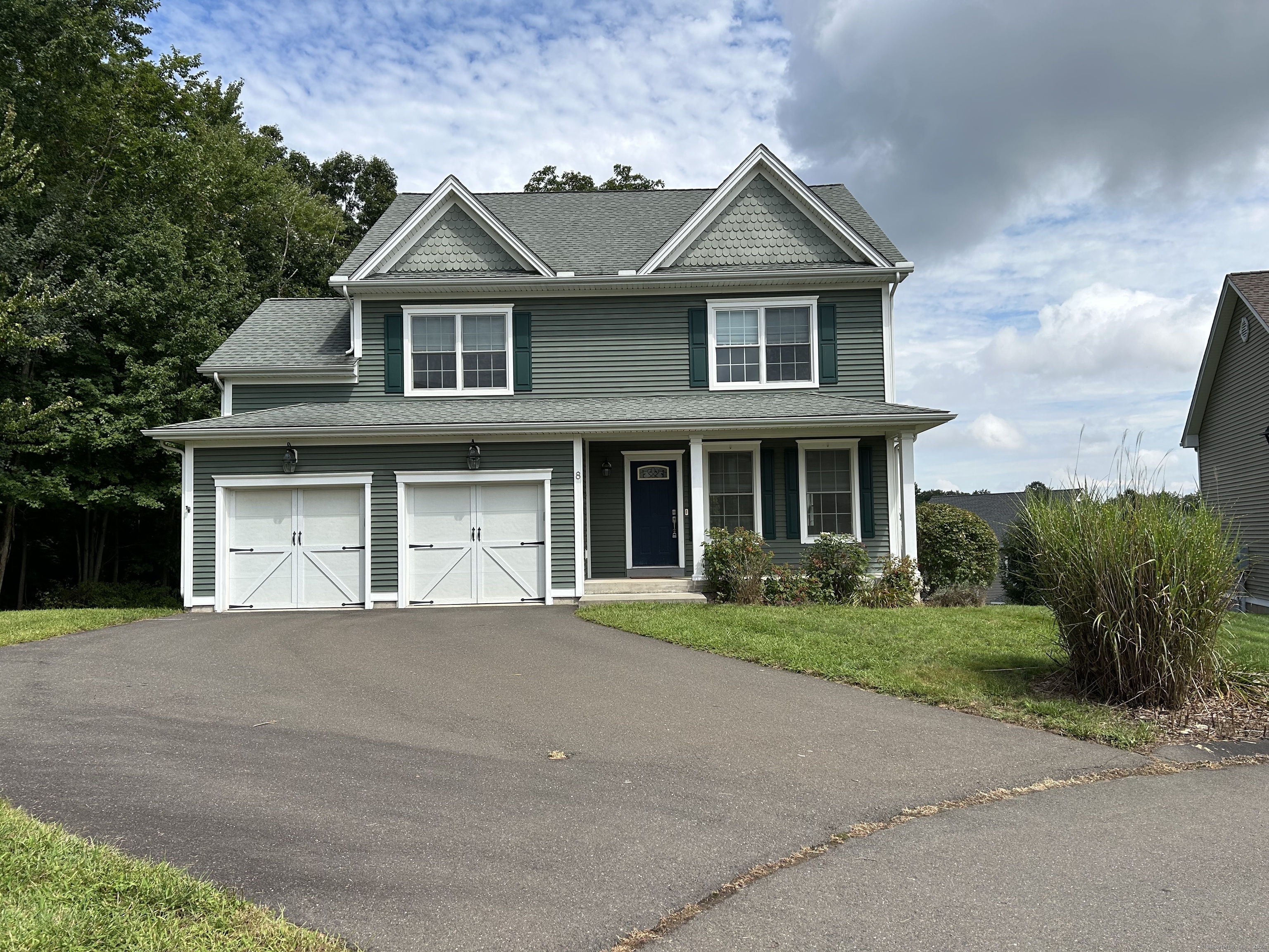 a front view of a house with a garden