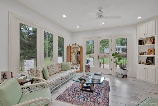 a living room with furniture and large windows