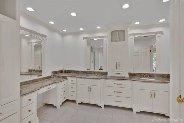 a spacious bathroom with a granite countertop sink mirror and double