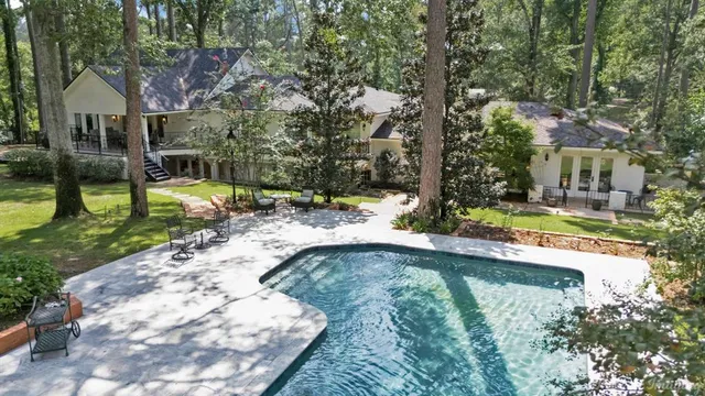 a view of a house with a yard balcony and tree s