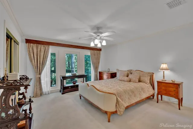 a bedroom with a bed and a large window with the outer view