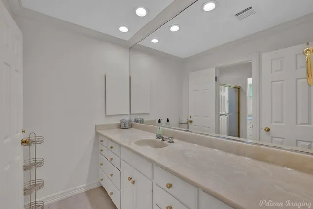 a bathroom with a double vanity sink and a mirror