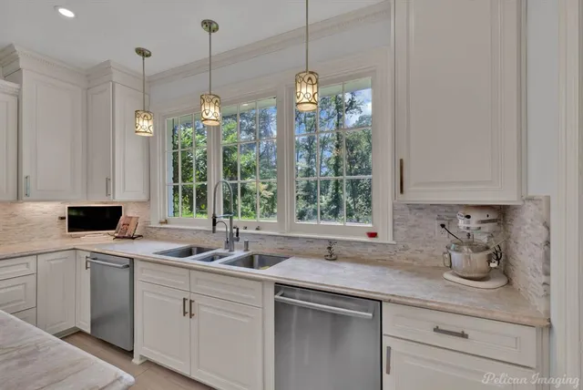 a kitchen with a sink and white cabinets