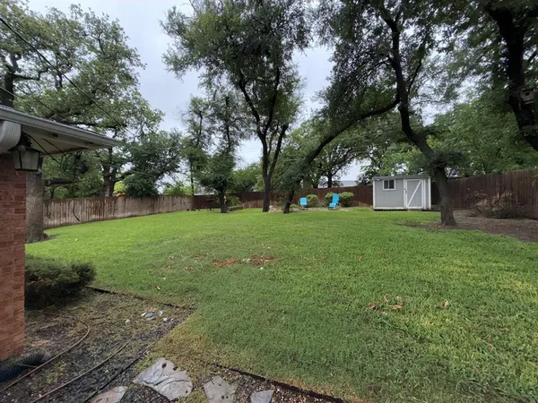 a view of a house with backyard space and sitting area