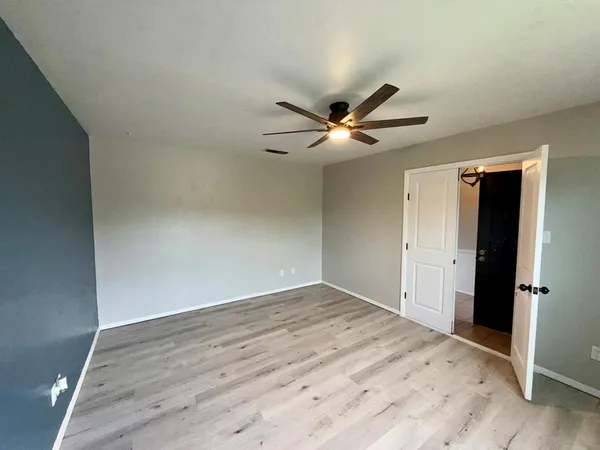 a view of a room with wooden floor