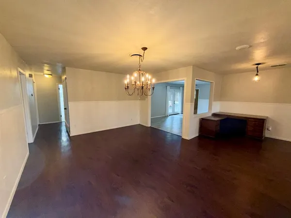 a kitchen with stainless steel appliances granite countertop a sink dishwasher a stove and a refrigerator