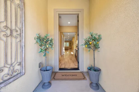 a dining room filled chandelier and wooden floor