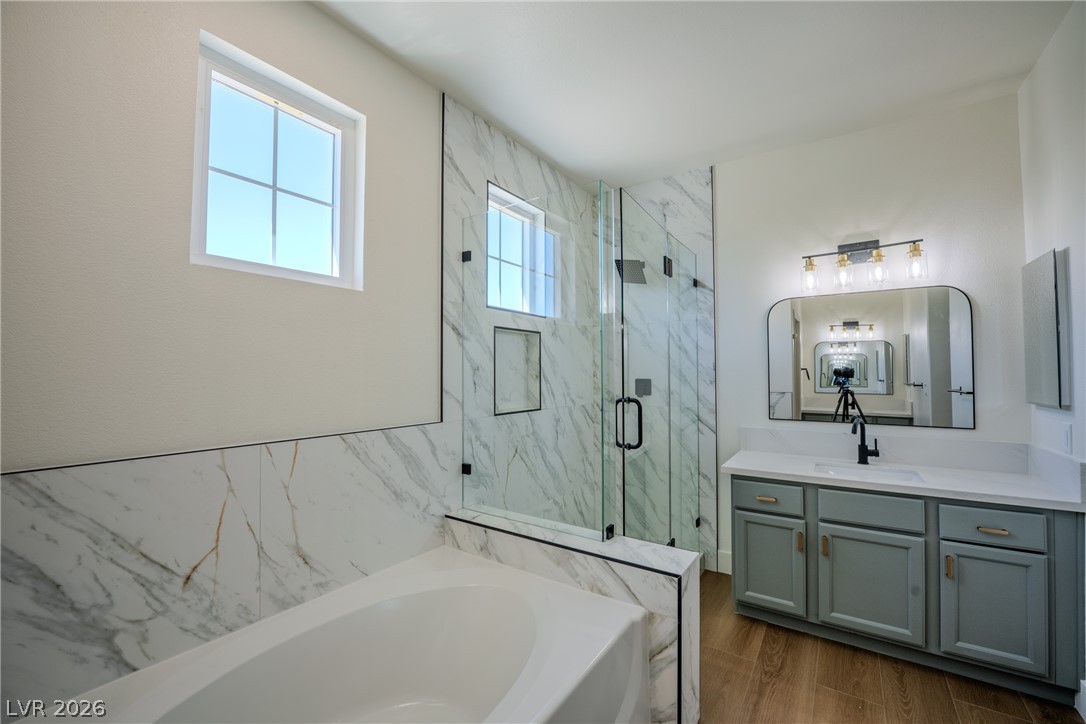 1832 Spring Summit Lane Las Vegas, NV 89134 - Photo 36 of 52 Luxurious bathroom retreat features a spacious soaking tub, a sleek walk-in shower, and a stylish vanity with a contemporary mirror.