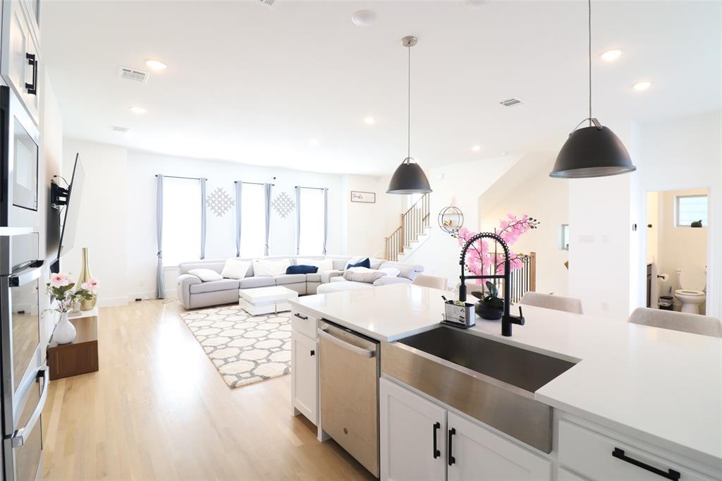 1205 Marc Place Rowlett, TX 75088 - Photo 17 of 30 a kitchen with a sink stove and wooden floor