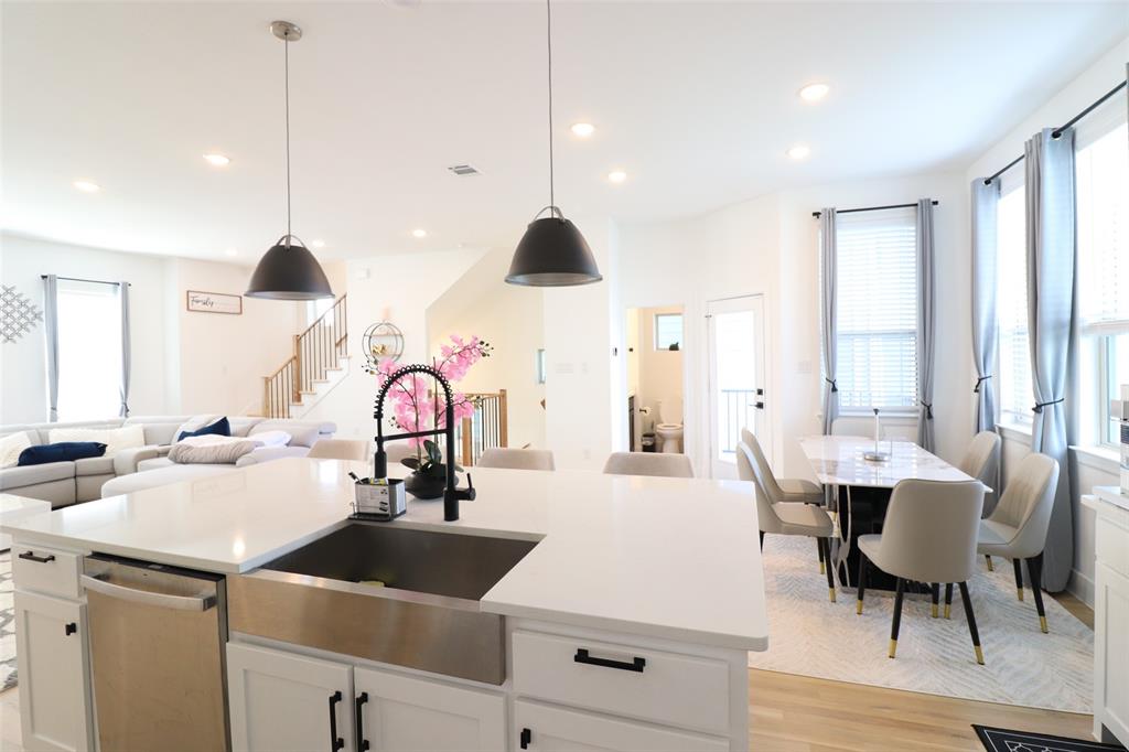 1205 Marc Place Rowlett, TX 75088 - Photo 18 of 30 a kitchen with a sink a counter space and living room view