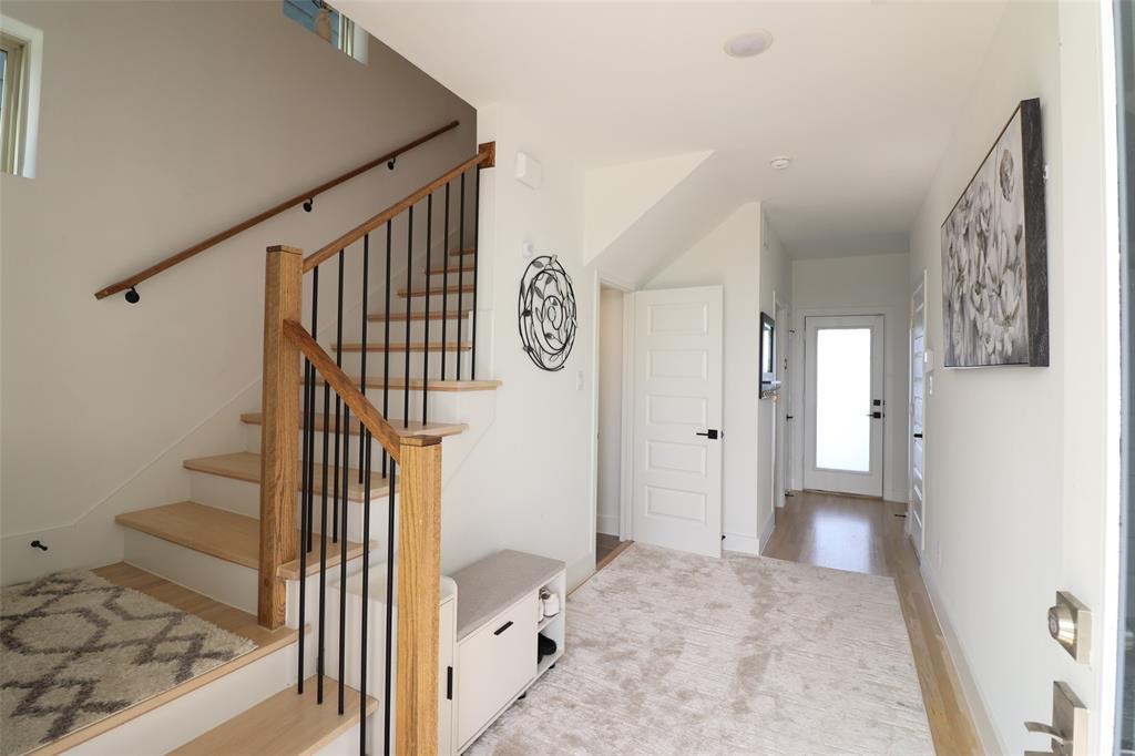 1205 Marc Place Rowlett, TX 75088 - Photo 2 of 30 a view of a hallway with wooden floor and a living room