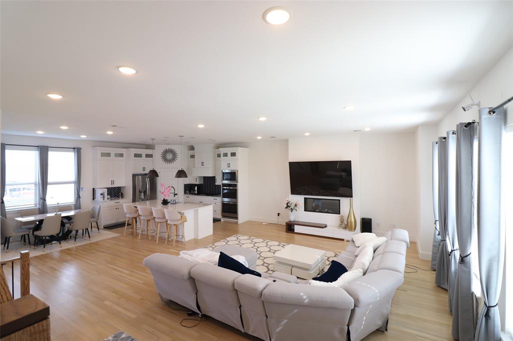 1205 Marc Place Rowlett, TX 75088 - Photo 22 of 30 a living room with furniture and a flat screen tv