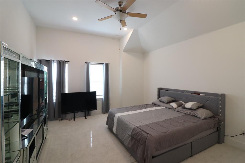 1205 Marc Place Rowlett, TX 75088 - Photo 23 of 30 a bedroom with a bed and a television