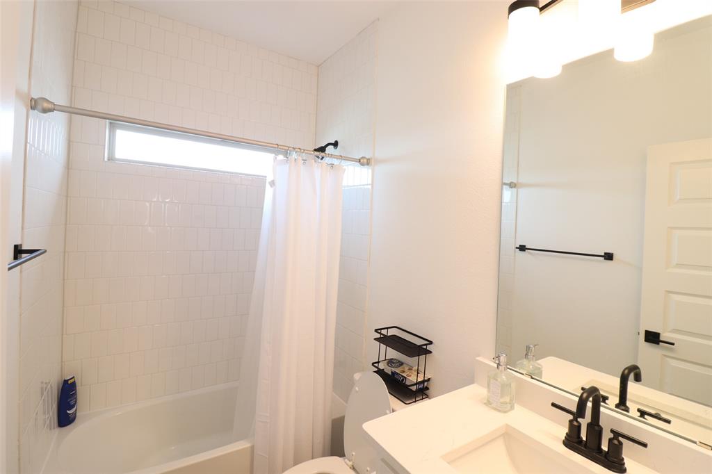 1205 Marc Place Rowlett, TX 75088 - Photo 29 of 30 a bathroom with a sink and a mirror