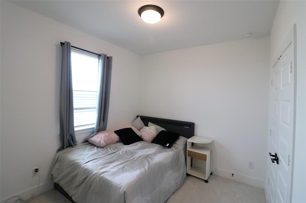 1205 Marc Place Rowlett, TX 75088 - Photo 30 of 30 a bedroom with a bed and window