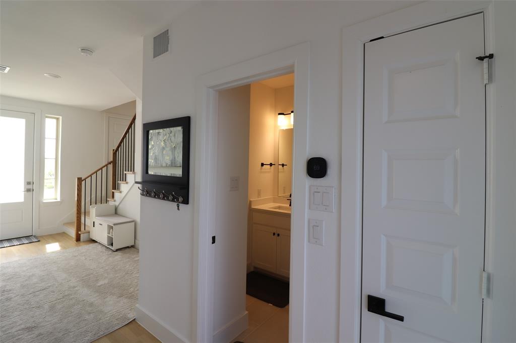 1205 Marc Place Rowlett, TX 75088 - Photo 7 of 30 a view of a hallway with bathroom and front door