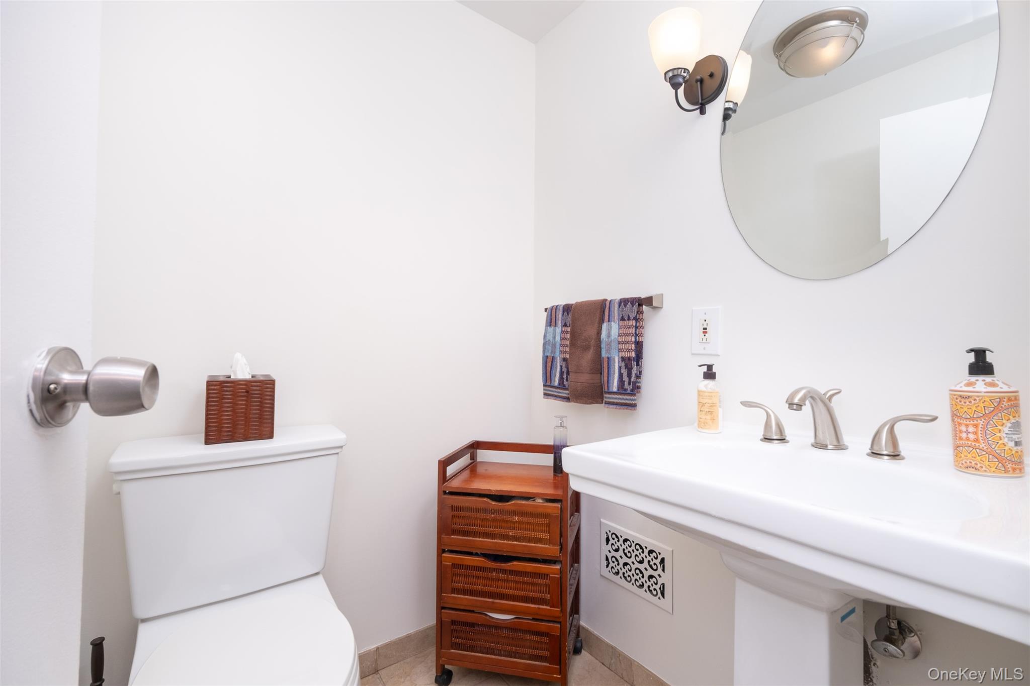 24 Sheldrake Place New Rochelle, NY 10804 - Photo 18 of 26 Half bathroom featuring toilet and a sink