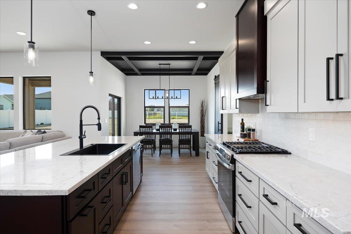 3068 Moonrise Road Twin Falls, ID 83301 - Photo 12 of 43 Coffered ceiling, wood-finish flooring, sliding glass doors, contemporary chandelier, and black barn door