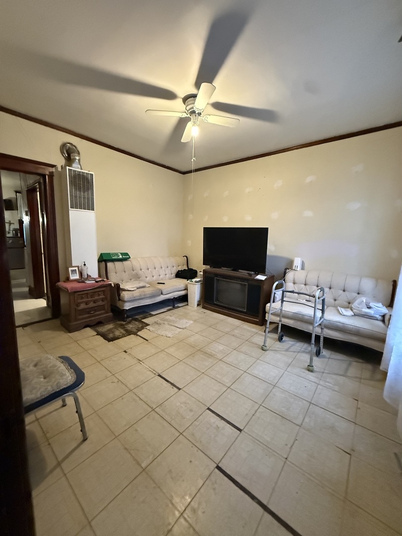 2847 South Harding Avenue Chicago, IL 60623 - Photo 2 of 12 a living room with furniture and a flat screen tv