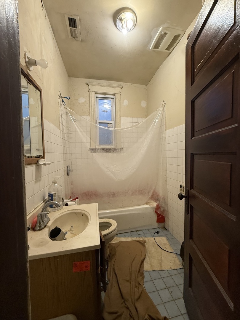 2847 South Harding Avenue Chicago, IL 60623 - Photo 4 of 12 a bathroom with a sink toilet and shower