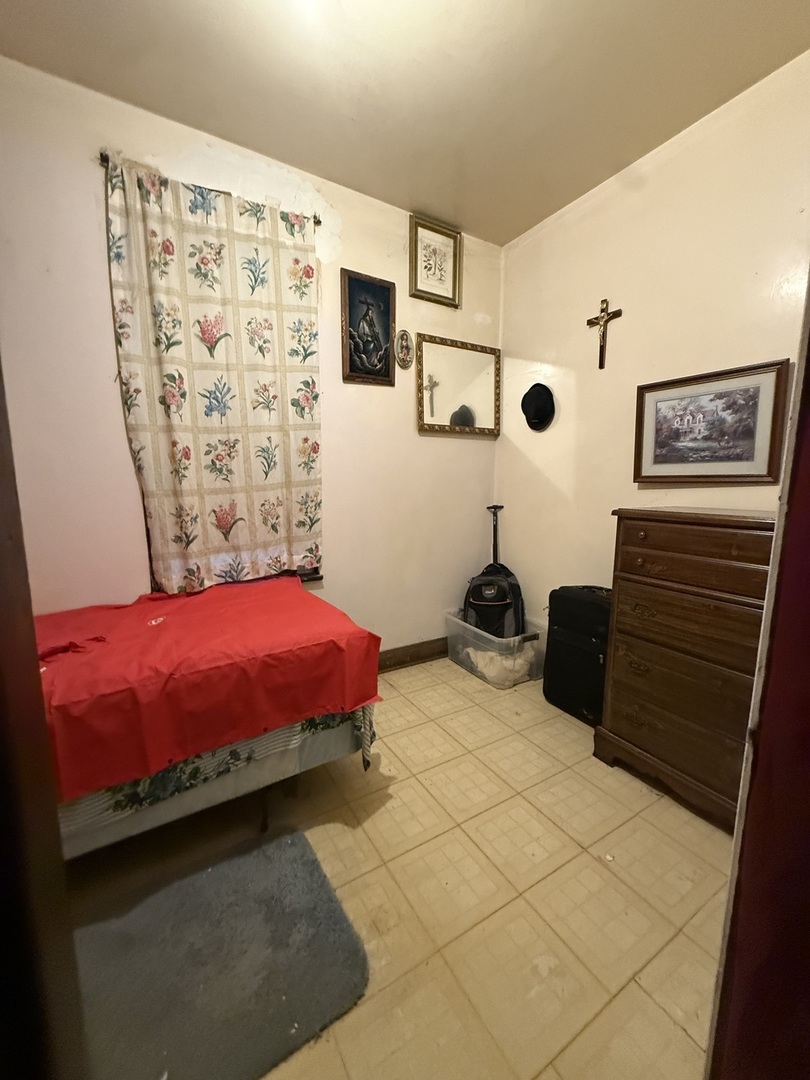 2847 South Harding Avenue Chicago, IL 60623 - Photo 6 of 12 a bedroom with a bed and a view of bathroom