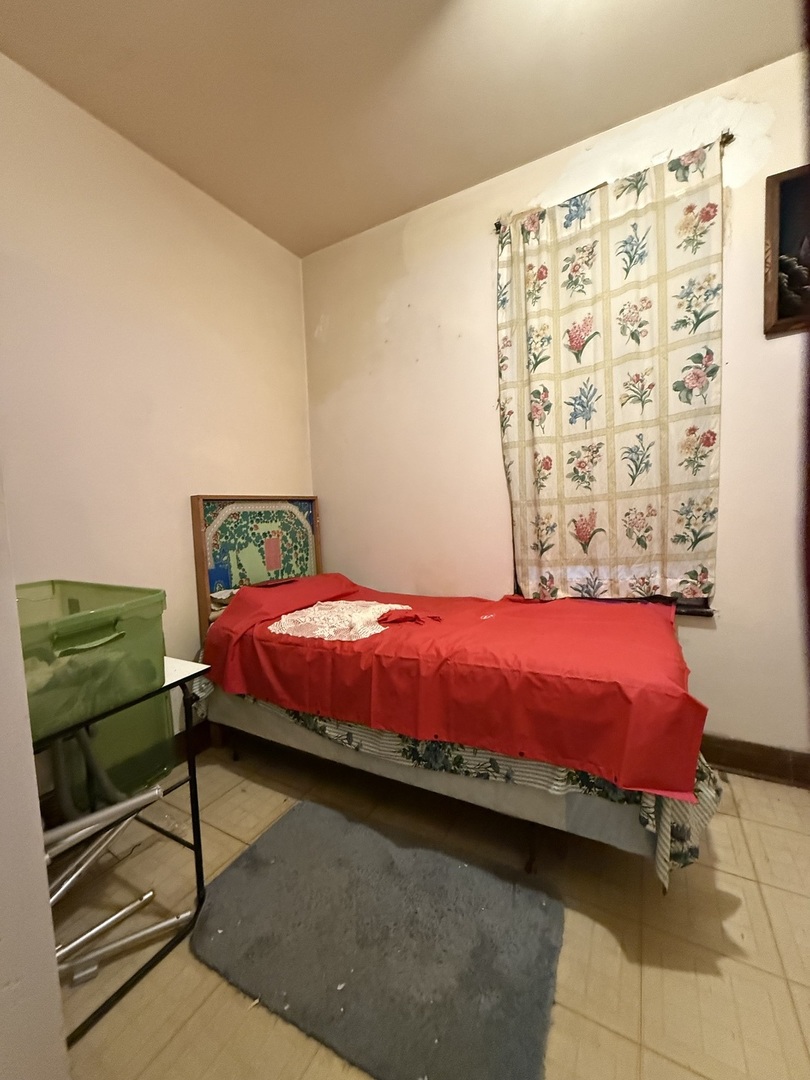 2847 South Harding Avenue Chicago, IL 60623 - Photo 7 of 12 a bedroom with a bed and a mirror