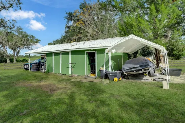 a view of a house with backyard porch and sitting area