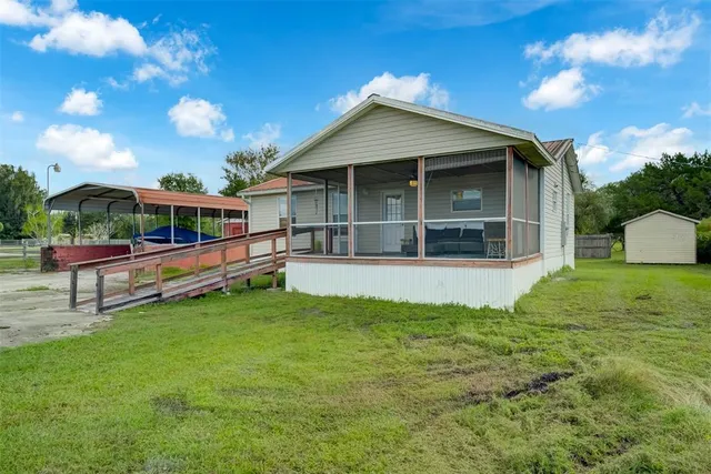 a living room with furniture a flat screen tv and a window
