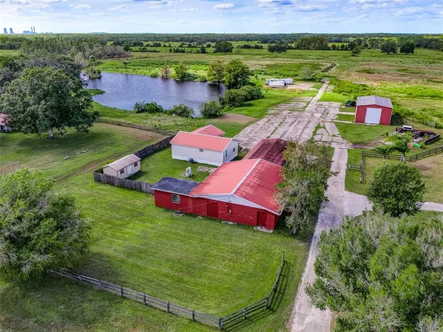 an aerial view of residential house with outdoor space and lake view
