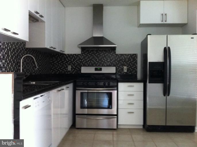 6394 Stagg Court Springfield, VA 22150 - Photo 1 of 10 a kitchen with granite countertop a stove and a microwave