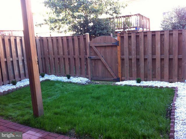 6394 Stagg Court Springfield, VA 22150 - Photo 6 of 10 a view of a backyard with wooden fence