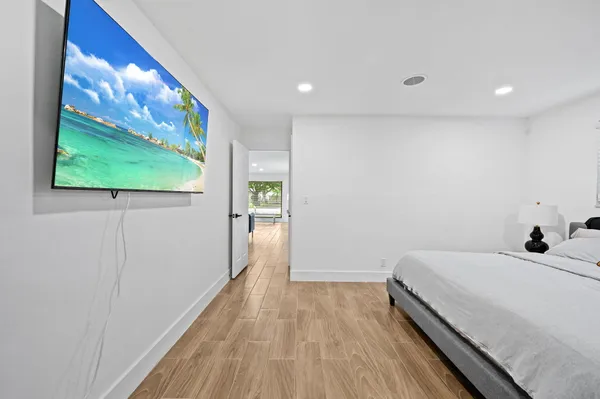 a bedroom with a bed and a painting on the wall