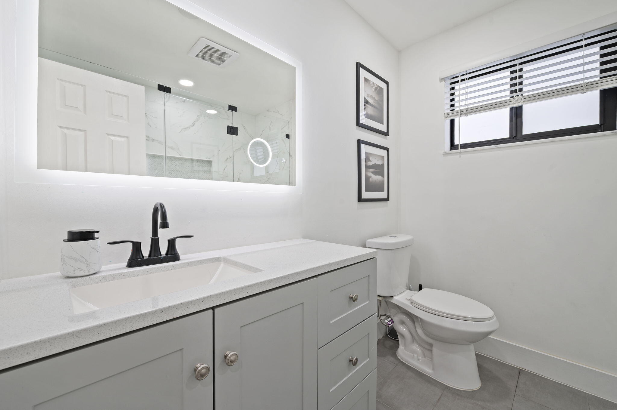 5420 Johnson Street Hollywood, FL 33021 - Photo 14 of 26 a bathroom with a toilet sink and mirror
