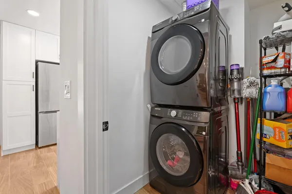 a view of a storage and utility room with dryer and washer