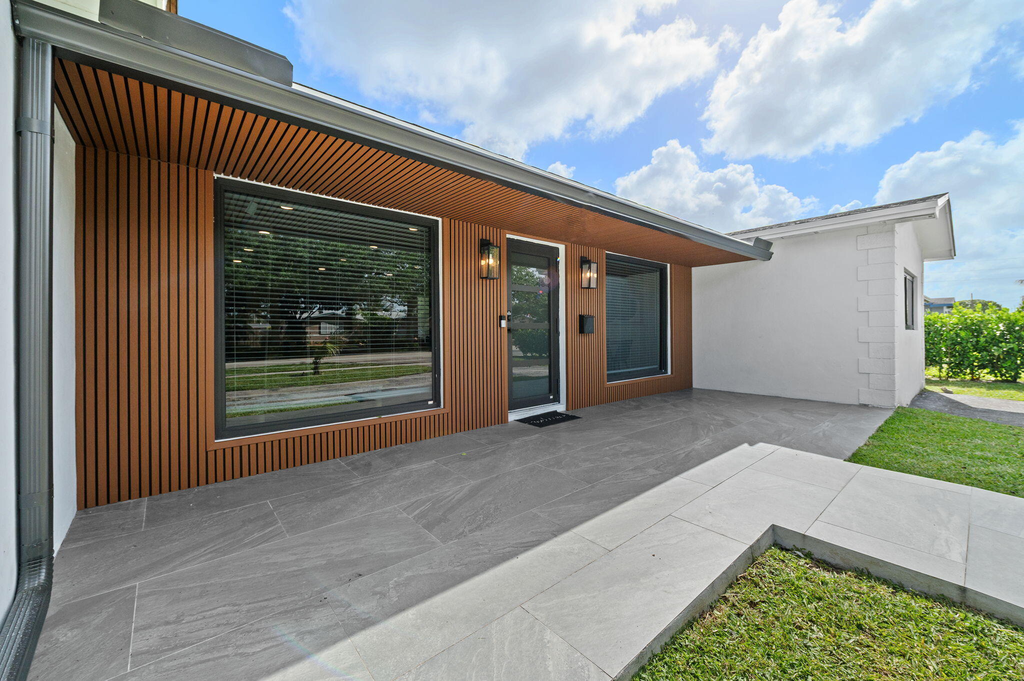 5420 Johnson Street Hollywood, FL 33021 - Photo 2 of 26 a view of a house with a porch