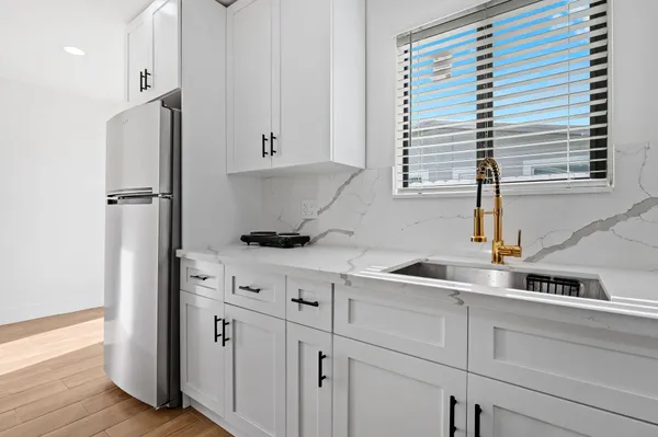 a kitchen with cabinets appliances and a window