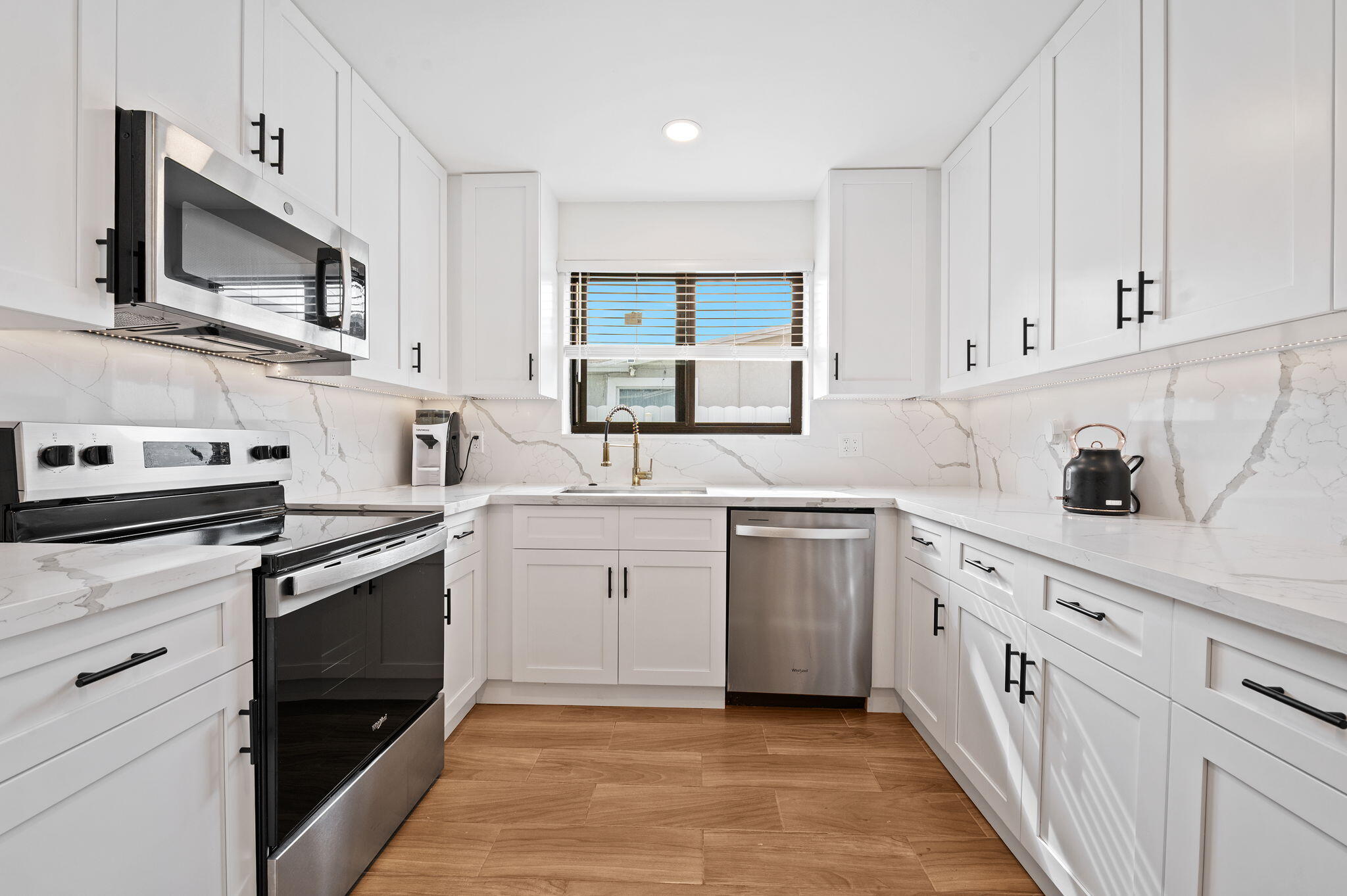 5420 Johnson Street Hollywood, FL 33021 - Photo 8 of 26 a kitchen with white cabinets appliances and a sink