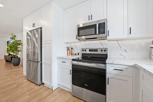 a kitchen with a refrigerator stove and microwave