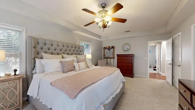 a bedroom with a large bed and a chandelier