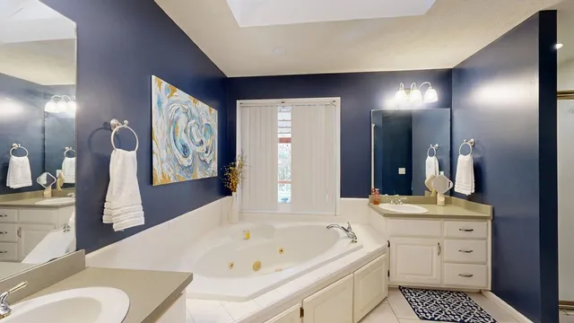 a bathroom with a sink a vanity and a mirror