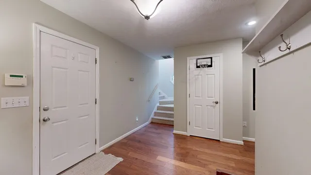 a view of a hallway with wooden floor
