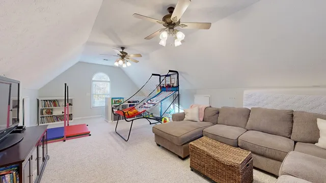 a living room with furniture a rug and a chandelier