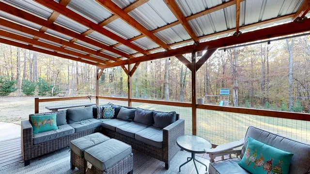 a living room with furniture and a floor to ceiling window